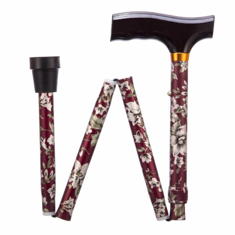 a red and white flowered handle with a black handle